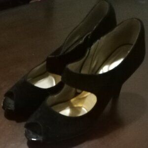 A pair of Black "Bandolino" heels with a gold zipper(size 10W)